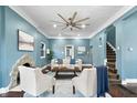 Beautiful living room boasting a fireplace, hardwood floors, and a ceiling fan at 914 Chase St, Anderson, IN 46016