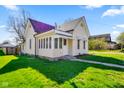 Angle view showing a quaint house with nice yard and a cozy porch area, ideal for a starter home at 93 Walnut St, Indianapolis, IN 46227