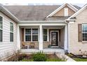Inviting front porch with seating, a neutral color scheme, and an attractive front door at 9559 Summer Hollow Dr, Fishers, IN 46037
