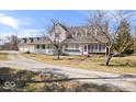 Charming white home featuring a spacious front porch and inviting entrance at 10333 E 211Th St, Noblesville, IN 46062