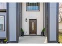 Inviting front entry featuring a beautifully designed door and stylish potted plants at 1533 Harlan St, Indianapolis, IN 46203