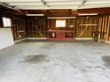 Spacious garage with ample storage space, work bench, and concrete flooring at 1607 Elmhurst Dr, Indianapolis, IN 46219