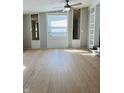 Bright living room with neutral walls, hardwood floors, ceiling fan, and plenty of natural light at 1607 Elmhurst Dr, Indianapolis, IN 46219