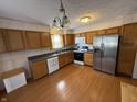 Traditional kitchen with wooden cabinets, stainless steel appliances, and hardwood floors at 1804 Austin Dr, Lebanon, IN 46052
