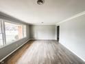 Sunlit living room features wood floors, fresh paint, and ample natural light from large windows at 3008 Nichol Ave, Anderson, IN 46011