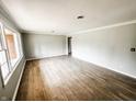 Bright, open living room with new hardwood flooring and fresh gray paint at 3008 Nichol Ave, Anderson, IN 46011