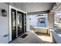 Inviting front porch with brick columns and a view of the neighborhood at 4055 Broadway St, Indianapolis, IN 46205