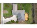 Aerial view of the home's roof, wooden deck, landscaped yard, and driveway from above at 4965 N 500 W, Columbus, IN 47201