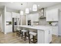 Spacious kitchen with large island, stainless steel refrigerator, and white cabinetry at 5647 Stetson Dr, Whitestown, IN 46052