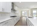 Bright, white kitchen with stainless steel appliances and quartz countertops at 5647 Stetson Dr, Whitestown, IN 46052