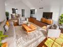 Bright living room with vaulted ceilings, hardwood floors, and a cozy seating area, with natural lighting at 6232 Behner Xing, Indianapolis, IN 46250