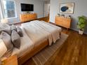 Comfortable main bedroom boasts hardwood floors, natural light, and stylish décor with neutral colors at 6232 Behner Xing, Indianapolis, IN 46250