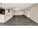 Open living room area with dark wood flooring showcasing the open concept and modern recessed lighting at 7326 Wooden Grange Dr, Indianapolis, IN 46259