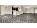 Spacious living room area with dark wood flooring showcasing the open concept and modern lighting fixtures at 7326 Wooden Grange Dr, Indianapolis, IN 46259