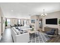 Open living room with neutral walls, modern furniture, decorative lighting, and an inviting atmosphere at 7326 Wooden Grange Dr, Indianapolis, IN 46259