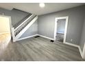 Open living room with sleek gray walls, staircase, and modern floors at 745 W 25Th St, Indianapolis, IN 46208