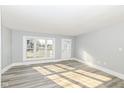 Bright, freshly-painted living room with new flooring and large window providing ample natural light at 821 S Lebanon St, Lebanon, IN 46052