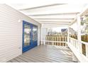 Covered porch showcasing a blue door, white railing, and built-in bench seating at 821 S Lebanon St, Lebanon, IN 46052