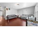Spacious living room featuring hardwood floors, neutral walls, and comfortable seating at 821 S Worth Ave, Indianapolis, IN 46241