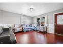 Bright living room with hardwood floors, natural light and comfortable seating at 821 S Worth Ave, Indianapolis, IN 46241