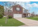 Attractive two-story home with brick accents, a front porch, and a well-maintained lawn at 8335 S Shady Trail Dr, Pendleton, IN 46064
