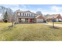 Charming two-story home featuring a brick and siding exterior with a welcoming front porch and two-car garage at 10111 Ironway Dr, Indianapolis, IN 46239