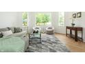 Bright and airy living room featuring stylish furniture, a modern rug, and ample natural light at 1026 Jefferson Ave, Indianapolis, IN 46201