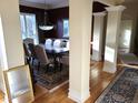Elegant dining room featuring a large table and decorative pillars at 12227 Redgold Run, Carmel, IN 46032