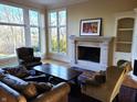 Bright living room with a fireplace, large windows, and comfortable seating at 12227 Redgold Run, Carmel, IN 46032