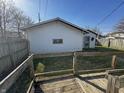 Backyard features a small wooden deck and detached garage offering outdoor enjoyment and storage at 2025 George St, Anderson, IN 46016