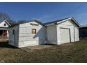 A detached two-car garage with siding offering ample parking and storage space at 2025 George St, Anderson, IN 46016