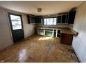 Spacious kitchen with wooden cabinets, laminate countertops, and hardwood patterned flooring at 2025 George St, Anderson, IN 46016