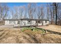 Charming white brick home with black shutters and a well-manicured lawn at 2408 E Stafford Pl, Martinsville, IN 46151