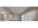Bright living room featuring light-colored walls, wood-look flooring, and large windows with vertical blinds at 2617 N Temple Ave, Indianapolis, IN 46218