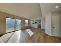 Open-concept living room with new flooring, large windows, and sliding glass doors at 2617 N Temple Ave, Indianapolis, IN 46218