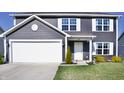 Inviting home featuring a classic design, neat landscaping, and a spacious two-car garage at 298 Rocky Rd, Greenfield, IN 46140