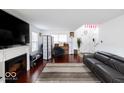 Bright living room features a fireplace, hardwood floors, and ample natural light at 3432 Shepperton Blvd, Indianapolis, IN 46228