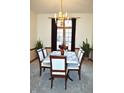 Cozy dining room featuring an elegant chandelier, floral centerpiece, and ample natural light at 37 Trotters Run, Brownsburg, IN 46112