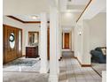 Bright and spacious foyer with elegant pillars and a view into the dining and living spaces at 37 Trotters Run, Brownsburg, IN 46112