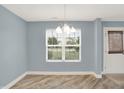 Inviting dining room featuring modern lighting and serene blue walls at 451 Filmore Dr, Westfield, IN 46074