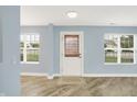 Bright entryway featuring wood-look flooring and a stylish front door at 451 Filmore Dr, Westfield, IN 46074