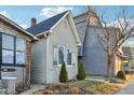 Quaint home with neutral siding, dark roof, mature trees and established landscaping at 546 E Merrill St, Indianapolis, IN 46203