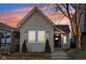 Charming home featuring mature trees, neutral siding, updated windows and front entrance with walkway at 546 E Merrill St, Indianapolis, IN 46203