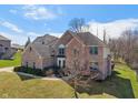 Beautiful two-story brick home with mature trees and a well-maintained front lawn at 5517 Westbourne Ct, Greenwood, IN 46143