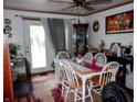 A warm dining area featuring a table with seating for six and a glass cabinet for storage at 618 S Tibbs Ave, Indianapolis, IN 46241