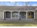 Inviting front porch with rocking chairs, perfect for enjoying quiet moments outdoors at 6201 S Carroll Rd, Indianapolis, IN 46259