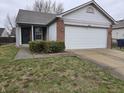 Charming single-story home with attached two-car garage, and well-maintained landscaping at 7128 Moon Ct, Indianapolis, IN 46241