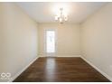 Dining room with hardwood floors, a door to the exterior, and neutral walls at 7726 Belmac Ln, Camby, IN 46113