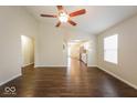 Open-concept living area with hardwood flooring and ample natural light at 7726 Belmac Ln, Camby, IN 46113