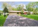 Charming ranch-style home with long driveway and attached two car garage at 8808 Manderley Dr, Indianapolis, IN 46240